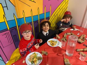 group of young boys eating Christmas dinner