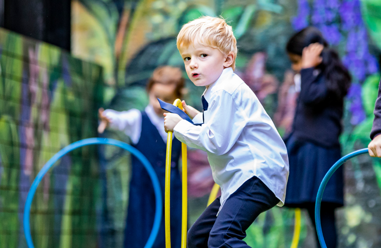 A child holding a hula hoop