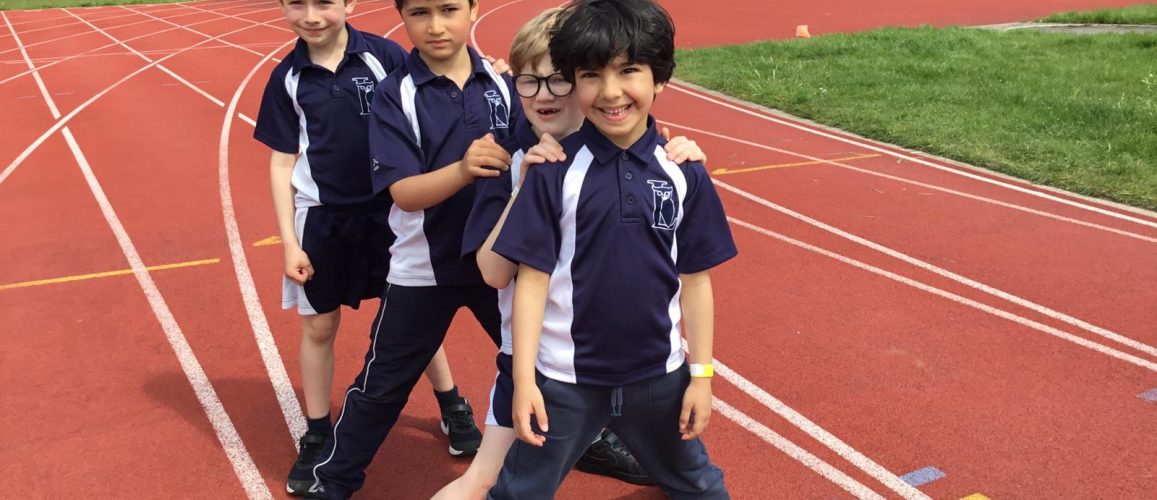 4 school boys on the athletics track