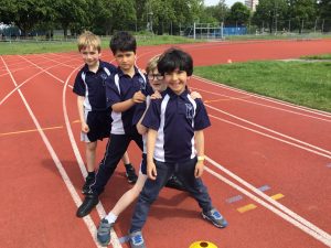 4 school boys on the athletics track