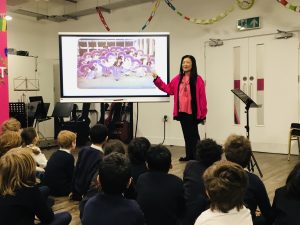 Ms Loh speaking in assembly to a group of pupils