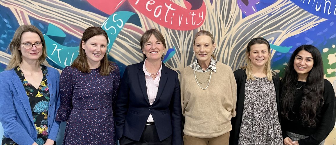 Female teachers stood smiling for International Womens Day