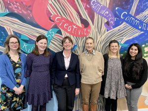 Female teachers stood smiling for International Womens Day