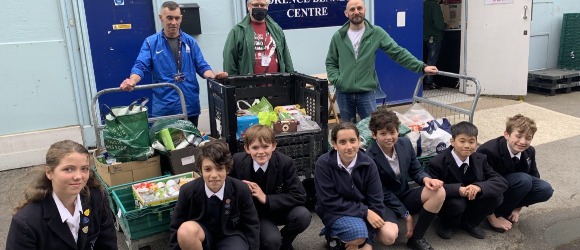 Students with the food they have provided to the food bank