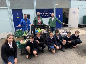Students with the food they have provided to the food bank