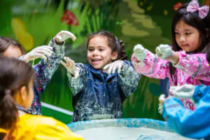 students in messy play - outdoor learning