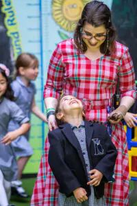 teacher looking down at a student