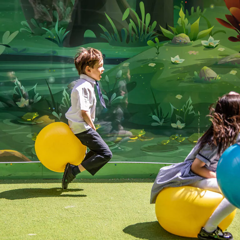 students on space hoppers