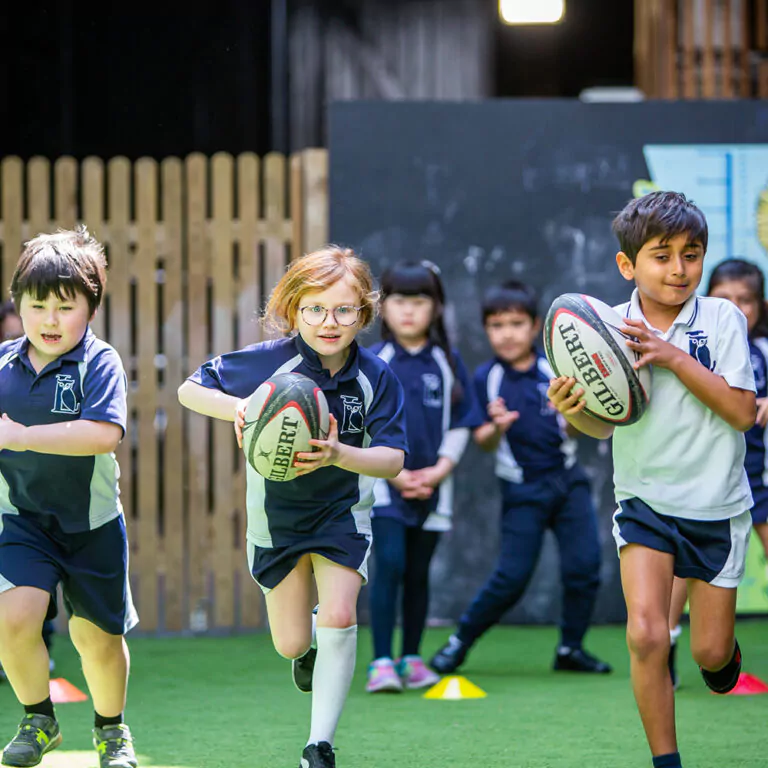 students running with rugby balls