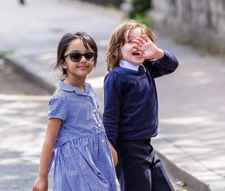 2 students walking over the road