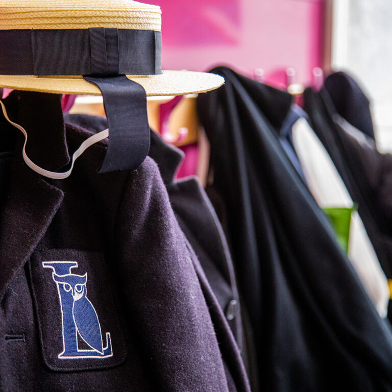 uniforms lined up on hooks