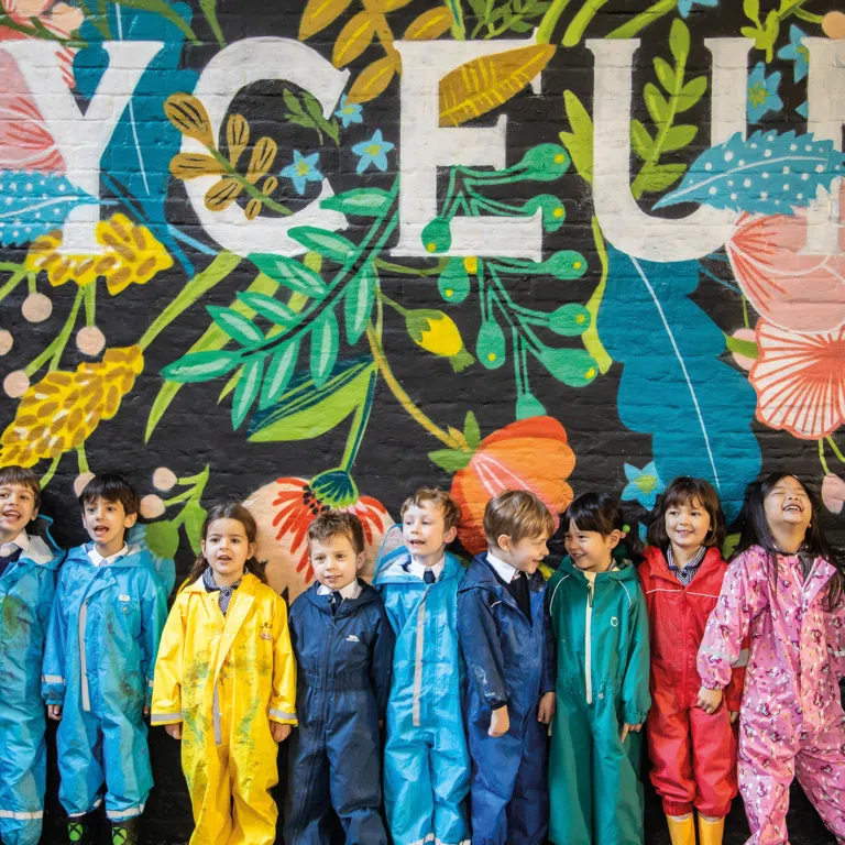 Pupils at the Lyceum School, a leading London independent school, standing before the school signage.