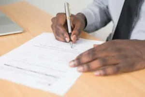 Boy filling in an application for a scholarship