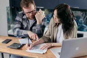 a couple calculating private school fees for their kids